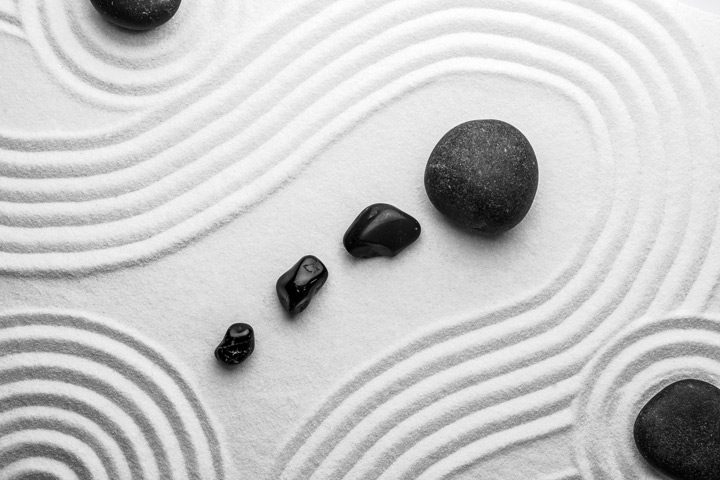 zen sand sculpture with black rocks - calm